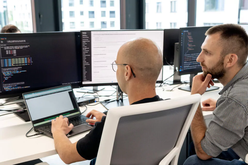 two people siting in-front of computer in mahton agency